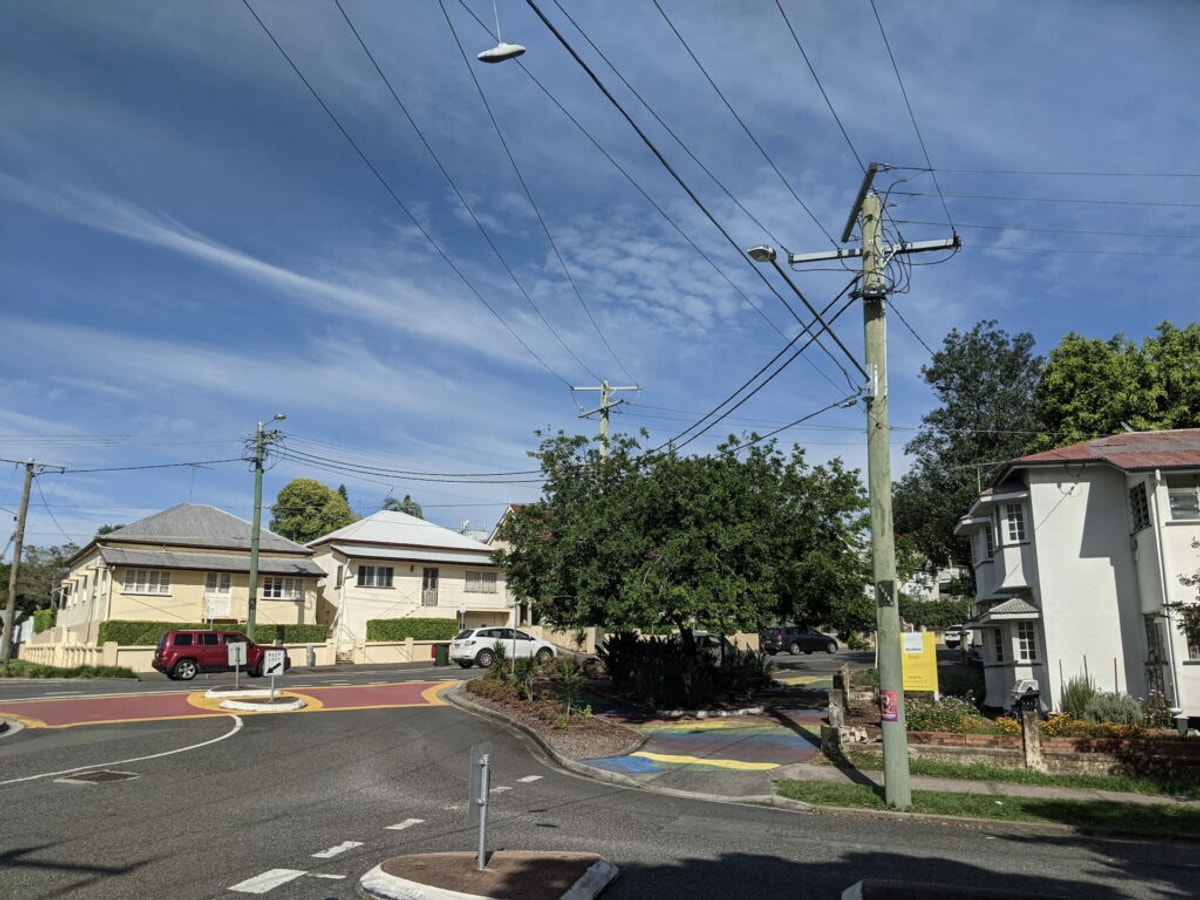 The corner of Vulture and Besant streets with the rainbow crossing visible across the road.