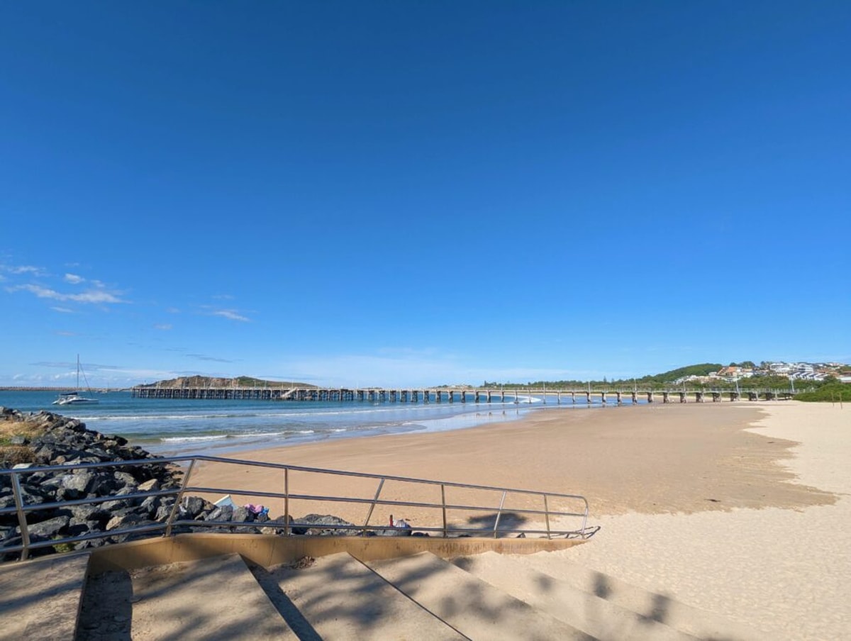 The Coffs Harbour harbour. Is this what it was named after? The jetty stretches out past the beach and into the water.