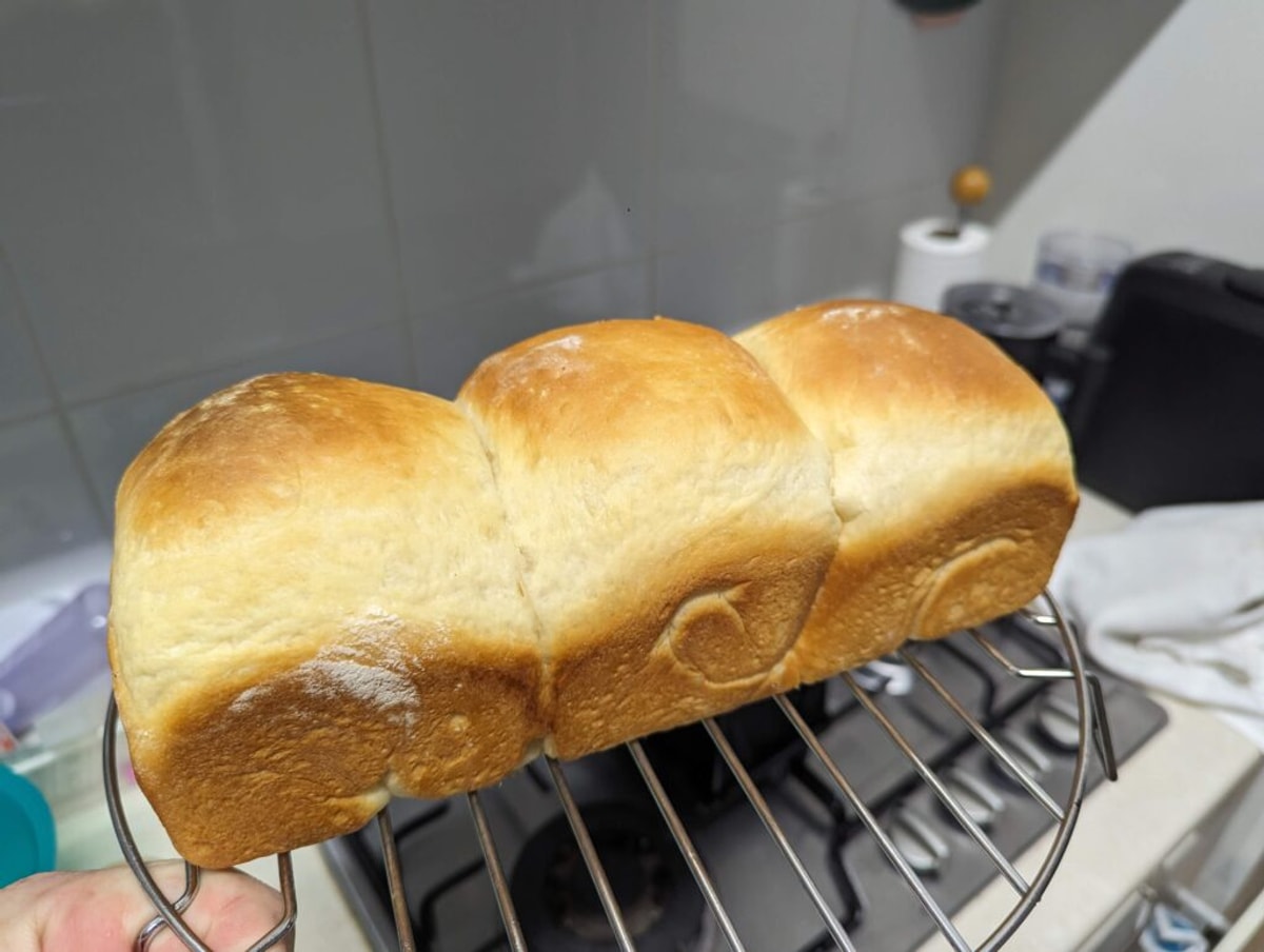 A loaf of perfect bread. It's got three domes, and is perfectly golden brown.